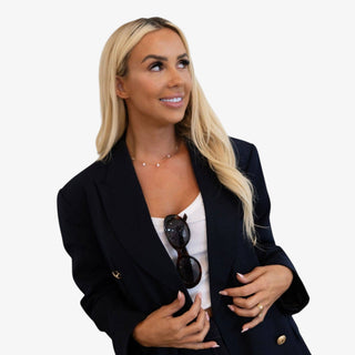 Dainty gold crystal station necklace with bezel set round stones worn layered on neckline