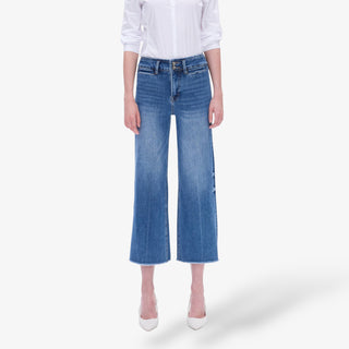 Person wearing blue jeans and a white shirt on a white background