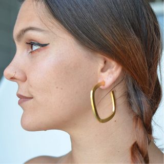 A pair of square hoop earrings with a gold plated finish.