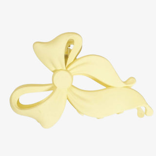 Butter yellow bow-shaped pendant on a white background