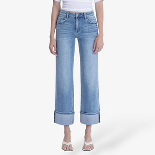 Light blue denim cuffed slim wide leg jeans and white sandals