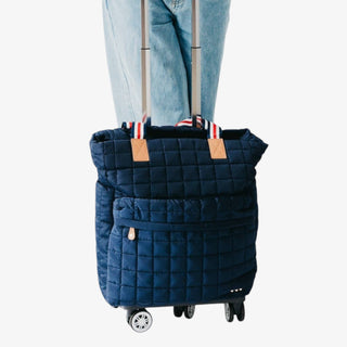 Jetsetter Quilted Rolling Tote in navy with quilted design, dual handles, and telescopic handle on wheels
