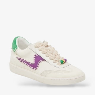 White leather sneaker with purple stitched detailing, green heel accent, and rope-style laces with colorful Mardi Gras beads for a festive sporty look.