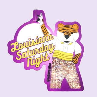 Illustration of a tiger character with 'Louisiana Saturday Night' text on a purple background