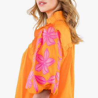 Close-up of puff sleeve detail on the Flora Embroidered Top with pink floral embroidery
