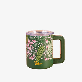 Green mug with floral design on a white background