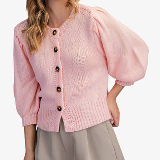 Blush puff sleeve button front sweater with ribbed hem styled with neutral shorts