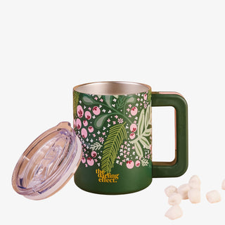 Green mug with floral design on a white background