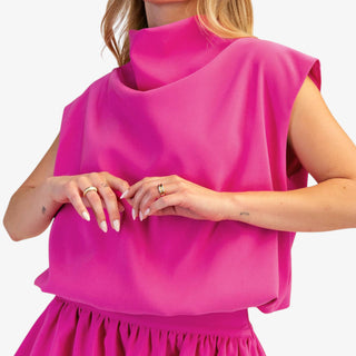 Mock neck balloon top in hot pink with draped silhouette and cap sleeves
