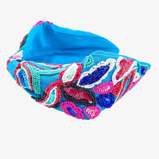 Bright blue headband with colorful beaded tropical design in pink, red, aqua, white, and navy.