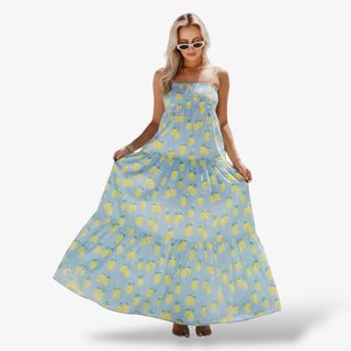 Woman wearing a blue dress with yellow pineapple pattern on a white background