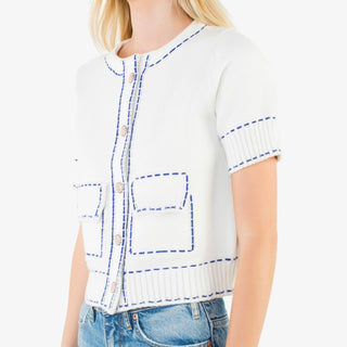 Contrast stitch knit button up top with short sleeves, decorative buttons, and tailored pockets in red or white