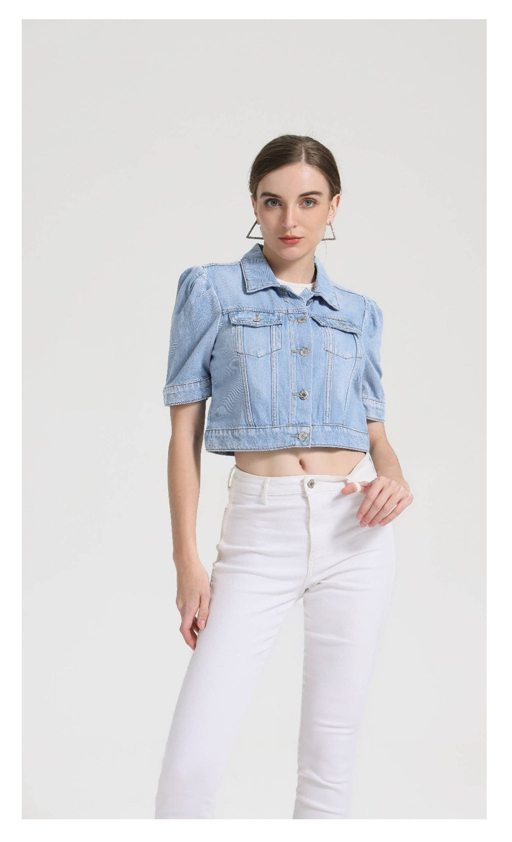 Light blue denim short puff sleeve jacket with button closure, two pockets and cropped length. 