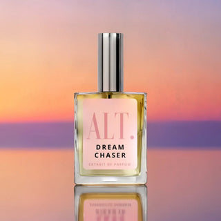 Perfume bottle labeled 'Dream Chaser' with a colorful gradient background