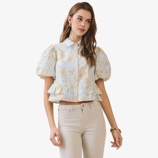 Blue floral peplum top with puff sleeves and collared button front detail styled with neutral high waisted pants