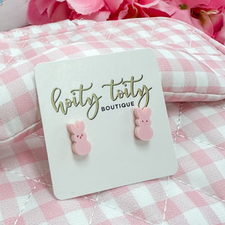 Pink bunny-shaped earrings on a card with 'horty toity boutique' text, against a pink checkered background.