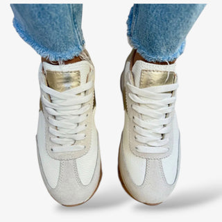 white leather lace up sneaker with metallic accents and grey suede close up front view