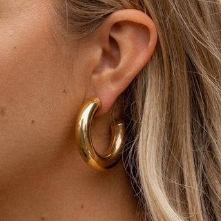 Jolie chunky gold hoop earrings with a smooth shiny finish
