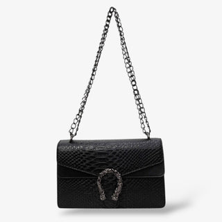 Black faux snakeskin shoulder bag with textured finish, chain strap, and silver horseshoe buckle detail for a sleek, edgy, and sophisticated look.