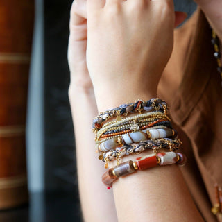 Woman wearing Catherine Page Confetti Bracelet Black and multiple earth tone bracelets 