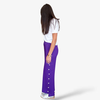 Purple pearl trim wide leg pants with side pockets and ankle slit paired with silver sneakers