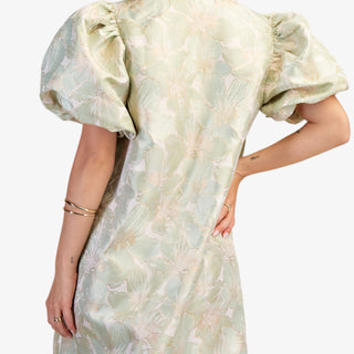 Sage floral puff sleeve mini dress with V-neckline and A-line fit on model wearing white flats