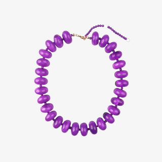 Chunky beaded necklace in purple with glossy oversized beads and gold clasp for statement jewelry flat lay view