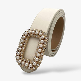Ivory leather belt with a rectangular gold buckle embellished with pearls and rhinestones, creating a chic and feminine statement accessory.