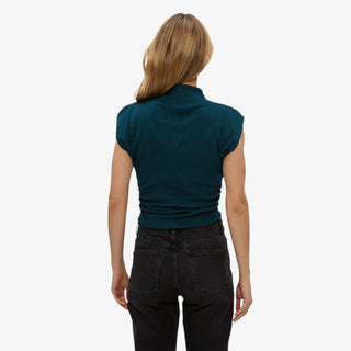 Woman wearing Michael Stars Amara Mock Neck Top in rainforest on a white background