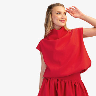 Mock neck balloon top in red with modern draped fit and cap sleeves