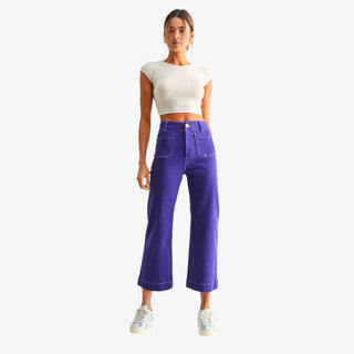 Purple wide leg jeans with high-rise waist, cropped length and front patch pockets styled with a white cropped top, front view