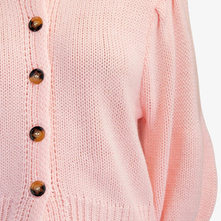 Blush puff sleeve button front sweater with ribbed hem styled with neutral shorts