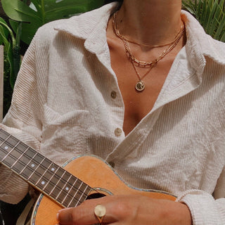 Three Little Birds gold necklace with dainty charm details