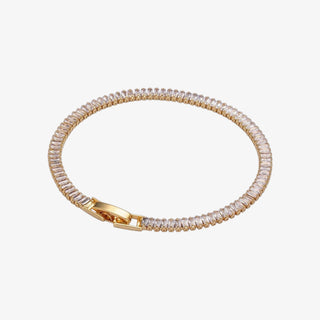Gold minimalist CZ tennis bracelet with fold-over clasp on white background