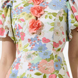 Floral mini dress with 3D rosette appliqué, puff sleeves, and pastel print detail ideal for spring outfits and wedding guest dresses