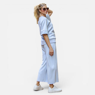 Light blue scuba knit cropped wide leg pants with pull-on waistband shown on model front view