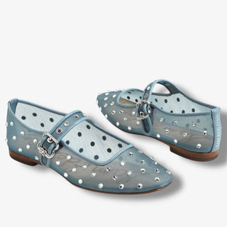 Pair of light blue shoes with clear embellishments on a white background