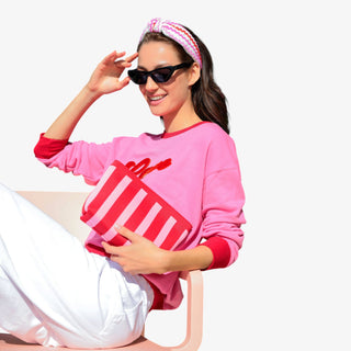 Model holding striped Shiraleah Isla Zip Pouch in green and white
Model with pink Shiraleah Isla Zip Pouch, styled with matching pink outfit

