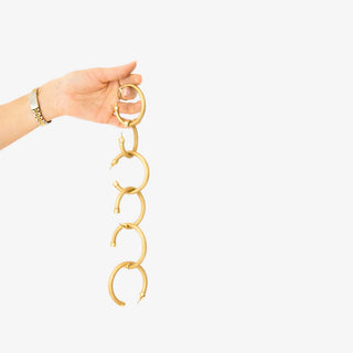 Small brushed gold hoop earrings with matte finish displayed in pink Hoo Hoops jewelry box
