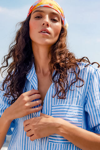 Detailed close-up image showcasing the blue pencil stripe fabrication, functional front pocket with barre stripes and button closure of the Melissa Nepton Kenny shirt.