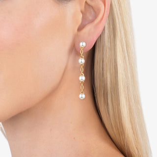 Gold chain drop earrings with ivory pearl accents in linear design