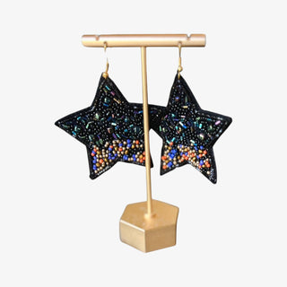 Black star earrings with black beads, iridescent accents, and colorful seed bead details on gold-tone hooks