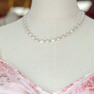 Pearl necklace on a mannequin with a pink dress