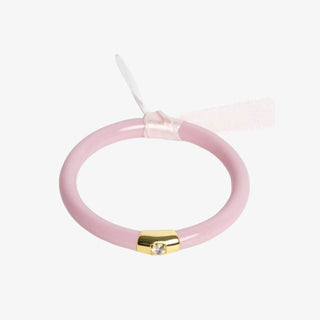 Pink bangle with a gold piece and diamond in the center wrapped with a light pink ribbon