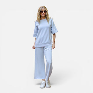 Light blue scuba knit cropped wide leg pants with pull-on waistband shown on model front view
