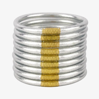 A stacked set of 6 silver bangles with a gold-tone charm