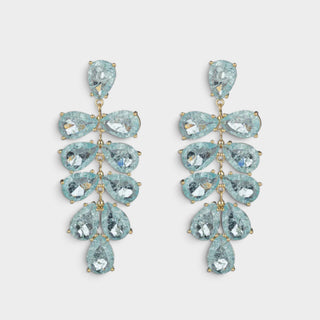 A pair of gold-tone drop earrings featuring light ambre green blue marquise-cut gemstones arranged in a cascading floral pattern, set against a plain light gray background.