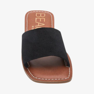 Black sandal with brown sole on a white background
