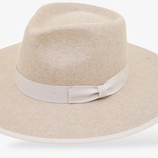 Beige wide-brimmed hat with a ribbon on a white background