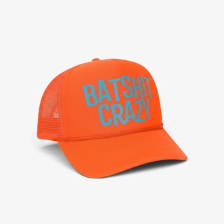 Orange Batshit Crazy trucker hat with blue lettering and mesh back, shown in front three-quarter product view.